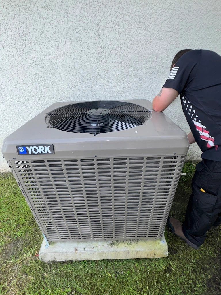 Fast Response Heating and Cooling technician in branded polo on a service call inside a Cape Coral home