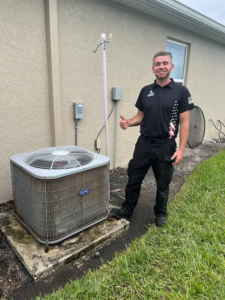 Disassembled evaporator coil being chemically cleaned outside a Cape Coral home with a Fast Response truck in the background