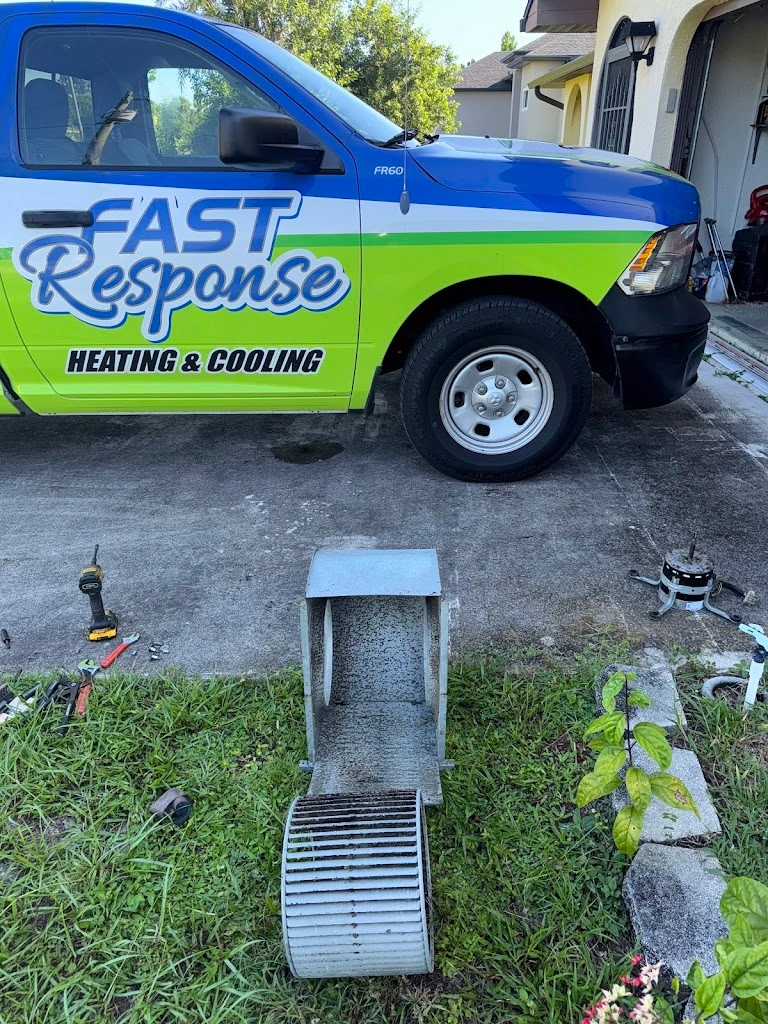 Two branded Fast Response Heating and Cooling vehicles parked in a Cape Coral driveway
