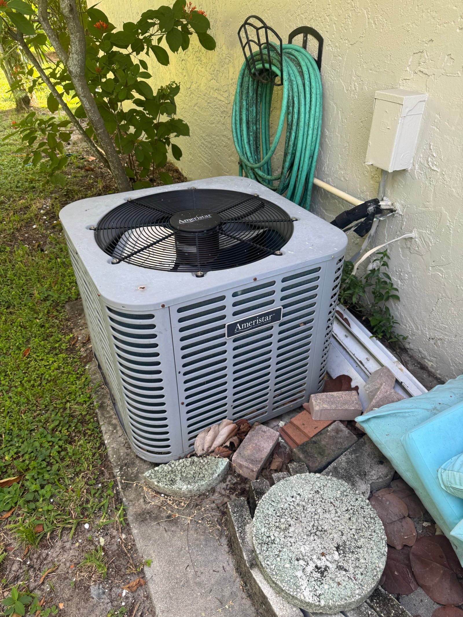 An outdoor Ameristar AC unit at a home in Fort Myers, Florida, during a tune-up by technician Ryan.